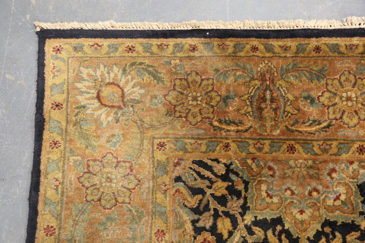 An Indian carpet, late 20th century, the charcoal field with overall palmettes, flowerheads and - Image 5 of 6