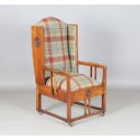 An Edwardian Arts and Crafts oak framed armchair, designed by George M. Ellwood, upholstered in