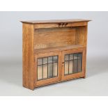 An Edwardian Arts and Crafts oak glazed hanging bookcase with chequer banded stringing, height 62cm,