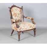A mid-Victorian walnut showframe armchair, the seat and back covered in machined tapestry, height