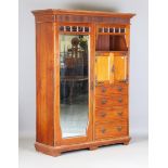 An Edwardian Arts and Crafts walnut wardrobe and matching dressing chest, probably by Maple & Co,