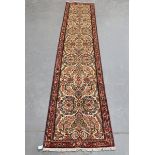 A Malayer runner, North-west Persia, late 20th century, the cream field with overall palmettes and