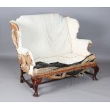 A late 19th/early 20th century George III style mahogany wing back settee, raised on carved cabriole