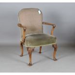 An early 20th century Queen Anne style walnut desk chair with open arms and finely carved legs,
