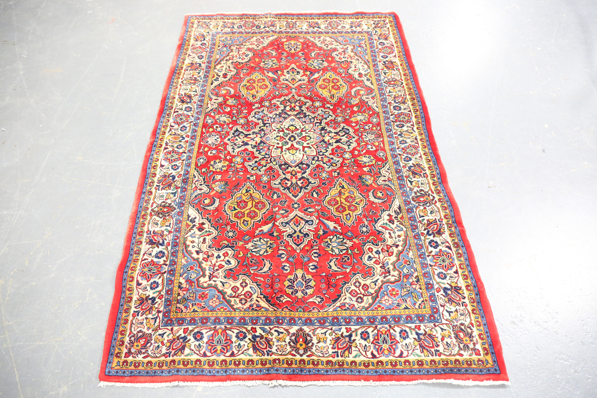 A Sarough rug, Central Persia, mid-20th century, the red field with a shaped medallion, within an