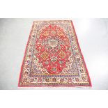 A Sarough rug, Central Persia, mid-20th century, the red field with a shaped medallion, within an