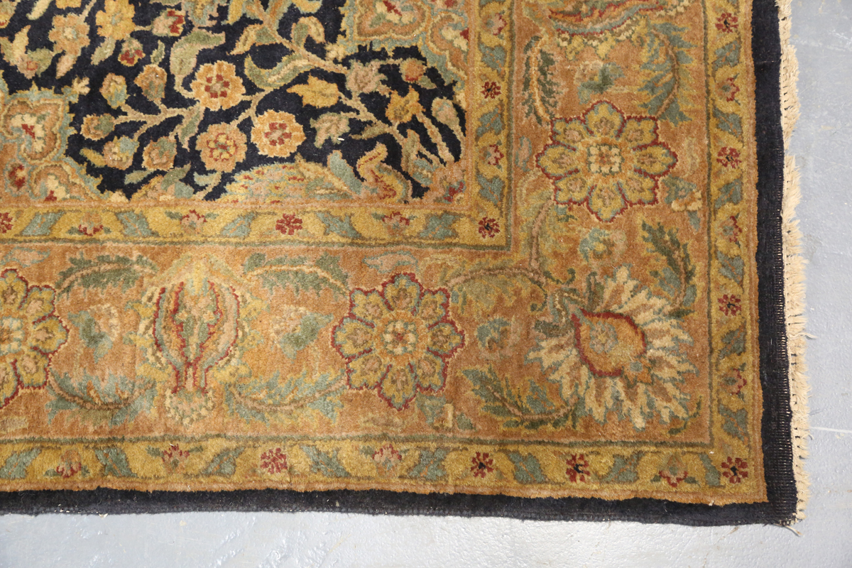 An Indian carpet, late 20th century, the charcoal field with overall palmettes, flowerheads and - Image 3 of 6