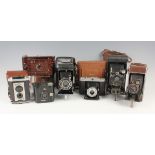 A collection of assorted cameras, including a Kodak No. 2 Hawkette brown Bakelite cased camera, an