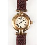 A Must de Cartier silver gilt circular cased lady's quartz wristwatch, the signed cream coloured