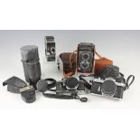 A small group of cameras and accessories, including a Yashiflex twin lens reflex camera, a