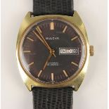 A Bulova Automatic gilt metal fronted and steel backed gentleman's wristwatch, the signed black dial