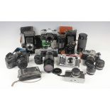 A collection of assorted cameras, including an Olympus OM10 with Vivitar 300mm 1:5.6 auto