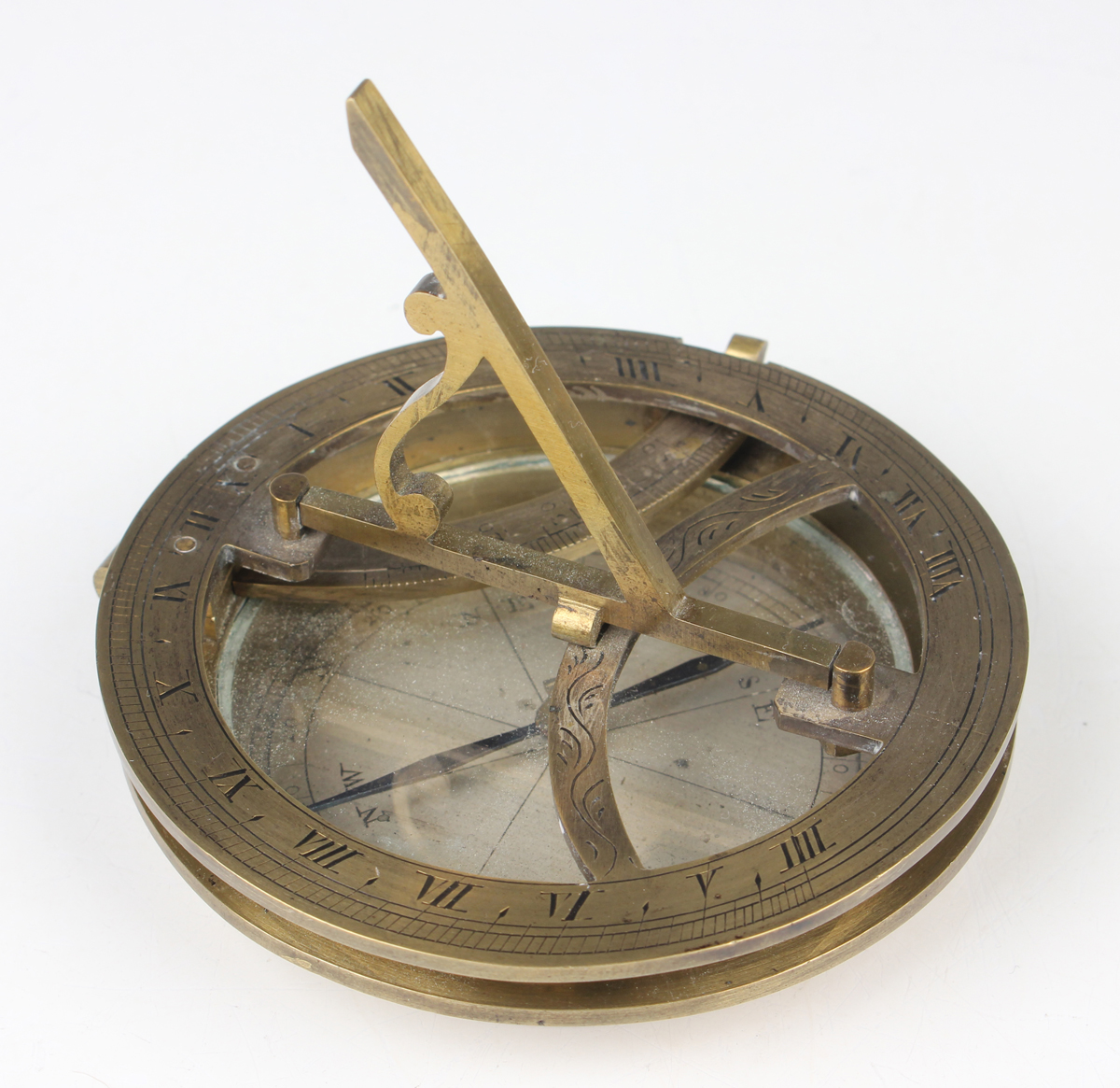 A 19th century brass equinoctial pocket sundial, the brass circular base with glazed silvered