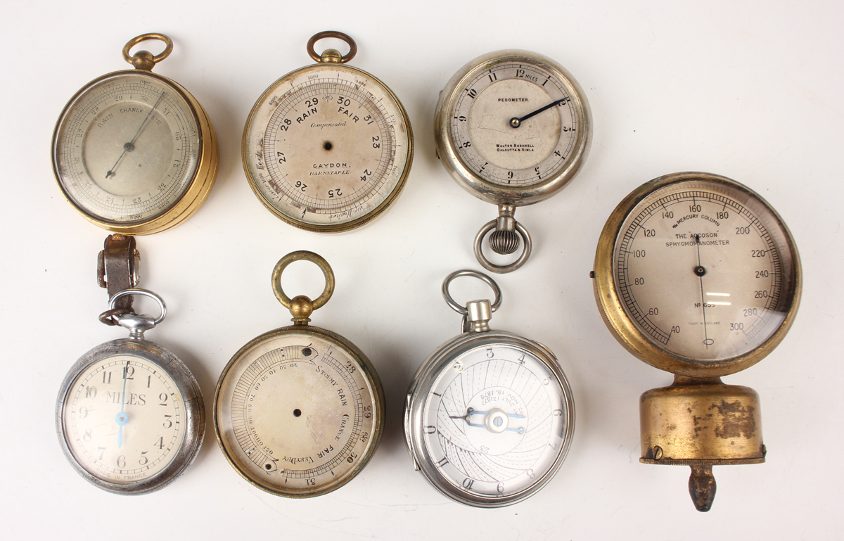 An early 20th century gilt lacquered brass cased pocket barometer with unsigned silvered dial,