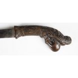 A mid-20th century Malaysian pedang dagger or shortsword with curved single-edged blade, blade