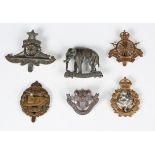 A large collection of British regimental cap and other badges, including India Artillery, Loyal