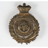 A Victorian gilt metal helmet plate badge for the First Surrey Rifles, the back with three screw