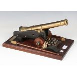 A late 20th century 1:5 scale model of a 19th century six-pound naval cannon, produced in cast