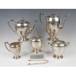 An early 20th century American sterling five-piece tea set, each of ovoid form with angular handles,