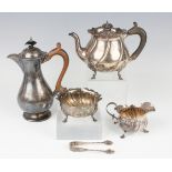 A late Victorian silver three-piece tea set of circular spiral reeded form, raised on scallop