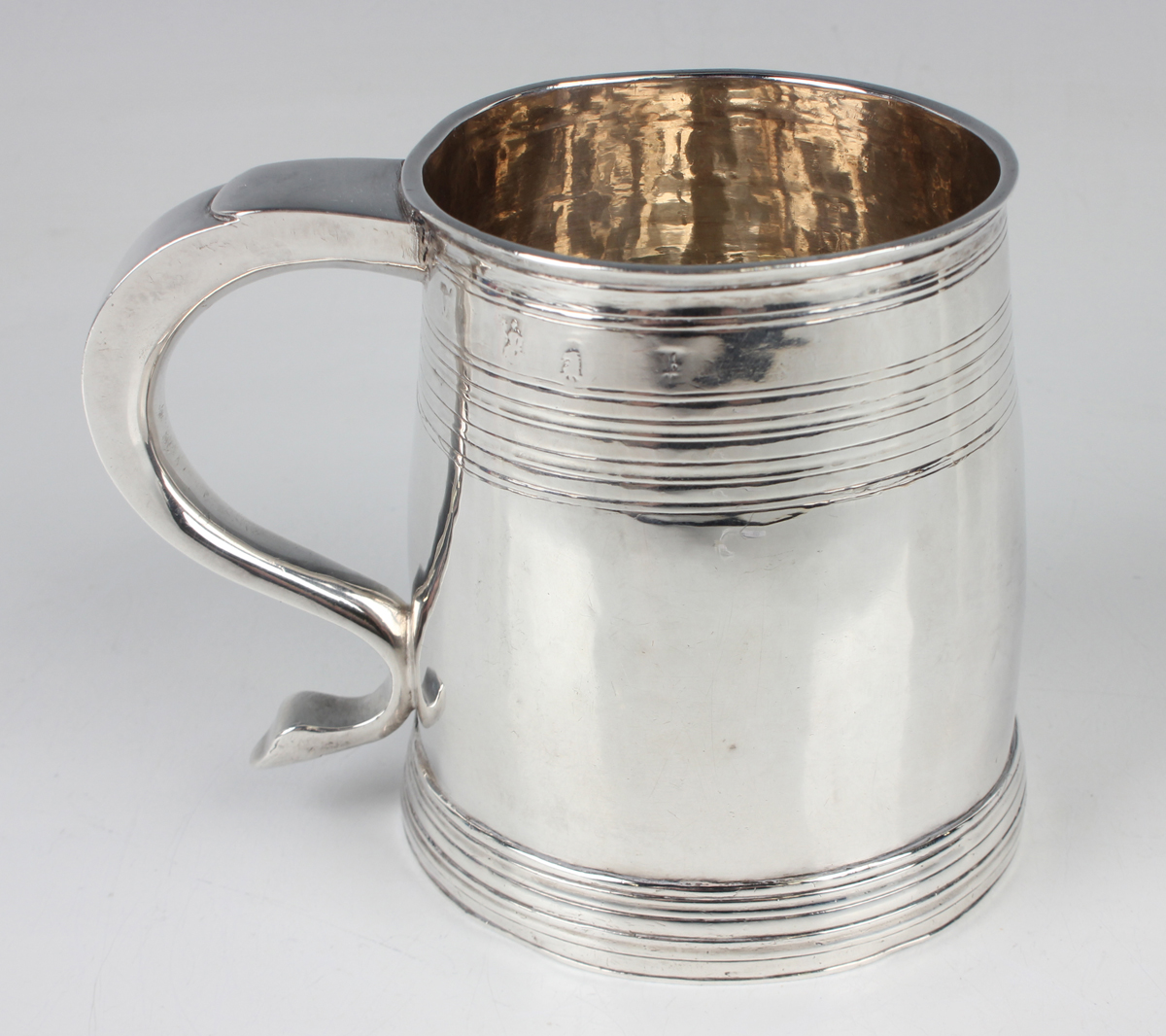 A Queen Anne Britannia standard silver mug of slightly swollen cylindrical form, decorated with