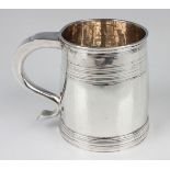 A Queen Anne Britannia standard silver mug of slightly swollen cylindrical form, decorated with