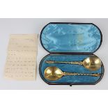 A pair of 19th century Continental silver gilt apostle spoons, each with twist stem and figural
