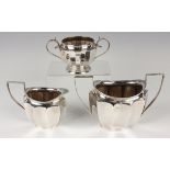 A George VI silver two-handled sugar bowl and matching milk jug of oval faceted form, Birmingham