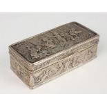 A late 19th century German silver rectangular box, the hinged lid decorated in relief with a scene