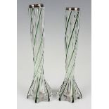 A pair of Edwardian silver mounted spiral moulded clear glass specimen vases, each with green