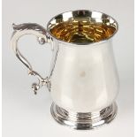 A George III silver baluster tankard with foliate capped scroll handle, on a circular foot, London
