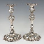 A near pair of early 20th century American sterling candlesticks, each urn shaped sconce with