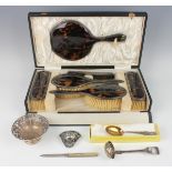 A George V silver and tortoiseshell six-piece dressing table set, comprising hand mirror, two hair