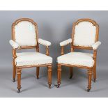 A pair of Victorian Gothic Revival blonde oak-framed elbow chairs by W. Williamson & Sons of