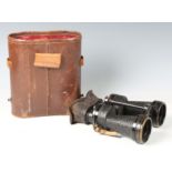 A pair of x5 Bino Prism MK 4 military binoculars, No. 7810, within a leather case (faults to case).