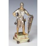 A modern silvered and gilt bronze figure of a medieval knight, raised on an onyx plinth, the