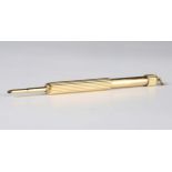 A gold cased propelling pencil of ribbed cylindrical form, the loop detailed '18ct', closed length
