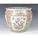 A Chinese porcelain jardinière, painted with birds and flowers, height 37cm, diameter 41cm.Buyer’s