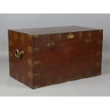 A mid-19th century teak and brass bound travelling trunk, the lid inset with a plaque detailed 'J.B.