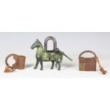 A Tibetan green patinated metal padlock in the form of a horse, length 13cm, together with two other