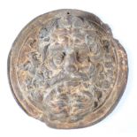 A 19th century cast iron circular wall plaque, relief decorated with a bearded male mask, diameter