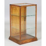 An early 20th century oak-framed table top collector's cabinet, fitted with two glass shelves and