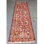 A South-west Persian flatweave runner, the ivory field with a single column of hooked medallions,