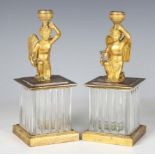A pair of late 19th/early 20th century gilt bronze figural candlesticks, each cast as a kneeling