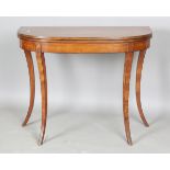 A Regency satinwood fold-over card table with ebony stringing and downswept splayed legs, height