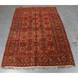 A small Afghan rug, mid-20th century, the charcoal field with overall palmettes, within a