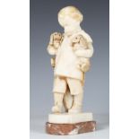 E. Wagner - an early 20th century Continental carved alabaster figure of a young boy carrying