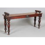 A Victorian mahogany window seat, raised on turned baluster legs, height 50cm, width 106cm, depth