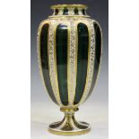 A Bohemian glass vase, late 19th century, the green ovoid body overlaid in white, cut with oval