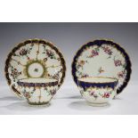A Worcester reeded French shape teacup and saucer, circa 1780, painted with floral swags divided